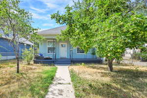 View of front of property with covered porch and roof with shingles