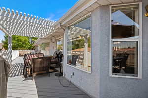 Wooden terrace with a pergola and area for grilling