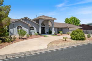 Mediterranean / spanish home featuring a tiled roof, concrete driveway, stucco siding, and a garage
