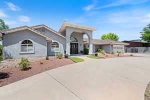 Mediterranean / spanish house featuring concrete driveway, stucco siding, an attached garage, and a tile roof