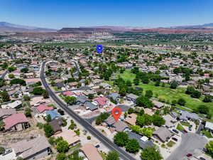 Aerial view of property's location with mountains and nearby suburban area