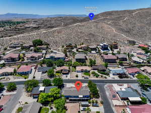 Aerial perspective of suburban area with a mountainous background