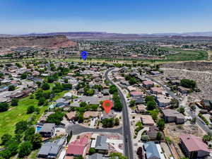Aerial perspective of suburban area featuring a mountainous background