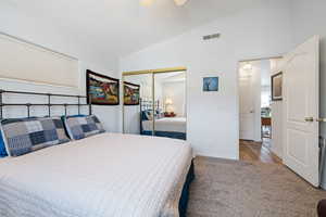 Bedroom with carpet floors, vaulted ceiling, a closet, and ceiling fan