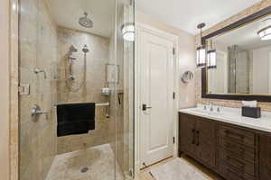 Full bath featuring a shower stall and vanity