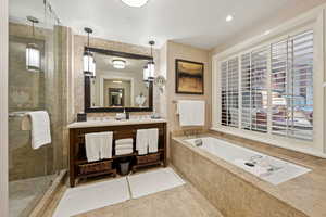 Bathroom with a shower stall, a garden tub, and vanity