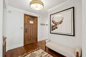 Foyer featuring wood finished floors and baseboards