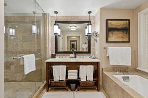 Full bath with a shower stall, a bath, and double vanity