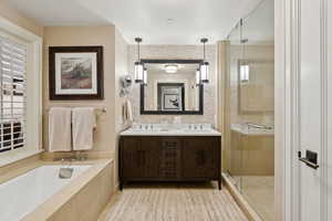 Full bath with a shower stall, a garden tub, and double vanity