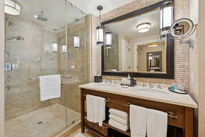 Bathroom with a shower stall and double vanity