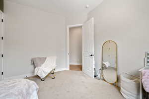 Carpeted bedroom with baseboards