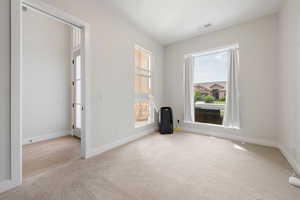 Carpeted empty room featuring baseboards