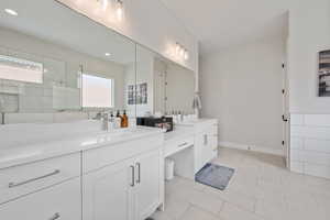 Full bath with vanity, a tile shower, tile patterned flooring, and recessed lighting