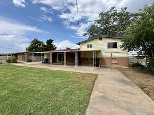 Rear view of house with a patio area and brick siding