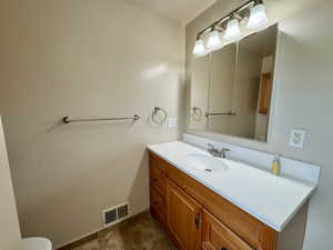 Half bath with vanity and toilet