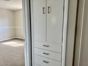Detailed view of carpet and baseboards