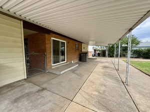 View of patio with a carport