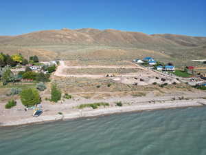 Aerial overview of property's location featuring a water and mountain view