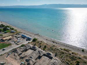 Aerial view of property and surrounding area featuring a water and mountain view