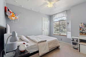 Bedroom featuring carpet and ceiling fan