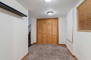 Unfurnished bedroom with a closet and carpet