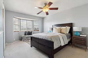 Bedroom with carpet flooring and a ceiling fan