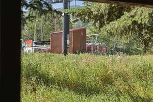 View of yard featuring a storage unit