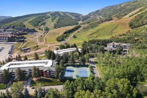Aerial view of property and surrounding area with a mountain backdrop