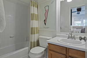 Full bathroom featuring vanity, shower / tub combo, and ensuite bathroom
