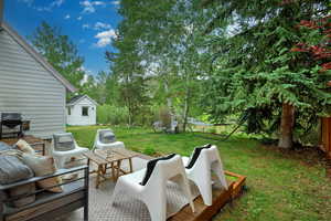 View of patio featuring an outdoor hangout area, area for grilling, and a shed