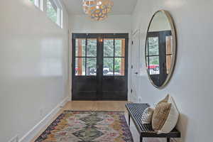 Doorway with french doors and wood finished floors