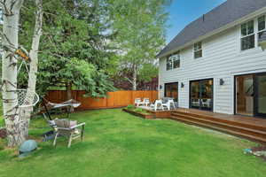 Fenced backyard with a wooden deck