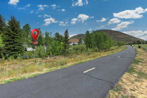 View of asphalt street featuring a mountain view