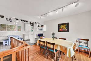 Dining area featuring track lighting and light wood-style floors