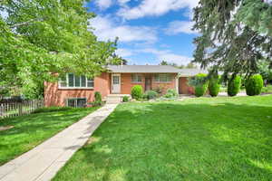 Ranch-style house with brick siding