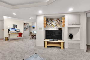 Carpeted living area featuring recessed lighting and baseboards