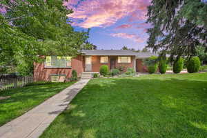 Single story home with brick siding