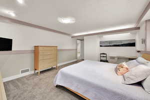 Bedroom featuring carpet flooring and baseboards