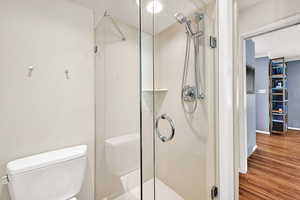 Bathroom featuring a stall shower and wood finished floors