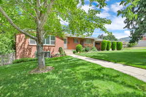 Ranch-style house with brick siding