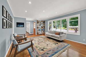 Living room with recessed lighting and wood finished floors