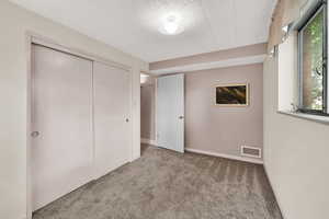 Unfurnished bedroom featuring carpet floors and a closet