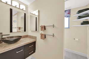 Bathroom with vanity and baseboards