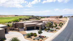 View of subject property featuring a mountainous background and a golf course