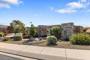 View of front of house featuring stone siding and stucco siding