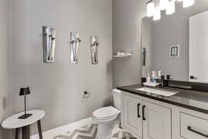 Half bath with vanity and toilet