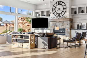 Living area with hardwood / wood-style floors and a fireplace