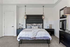 Bedroom with baseboards and light carpet