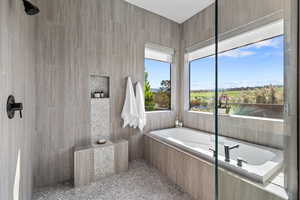 Full bathroom featuring a garden tub, a tile shower, and tile patterned floors