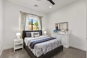 Carpeted bedroom with ceiling fan and recessed lighting